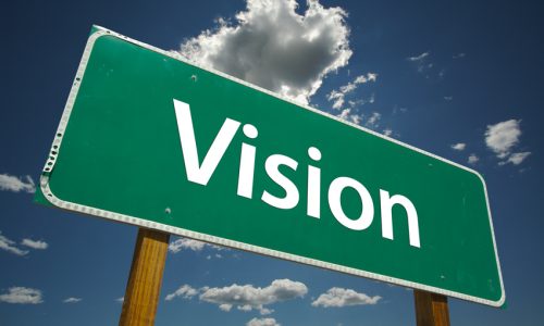 Vision Road Sign with dramatic blue sky and clouds.